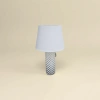 The white lampshade is paired with a black cylindrical lamp base featuring star-shaped patterns Specification image